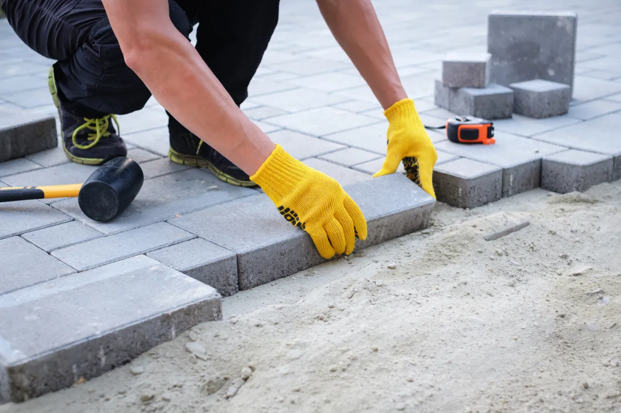 Craftsman laying pavers for a walkway in New Jersey