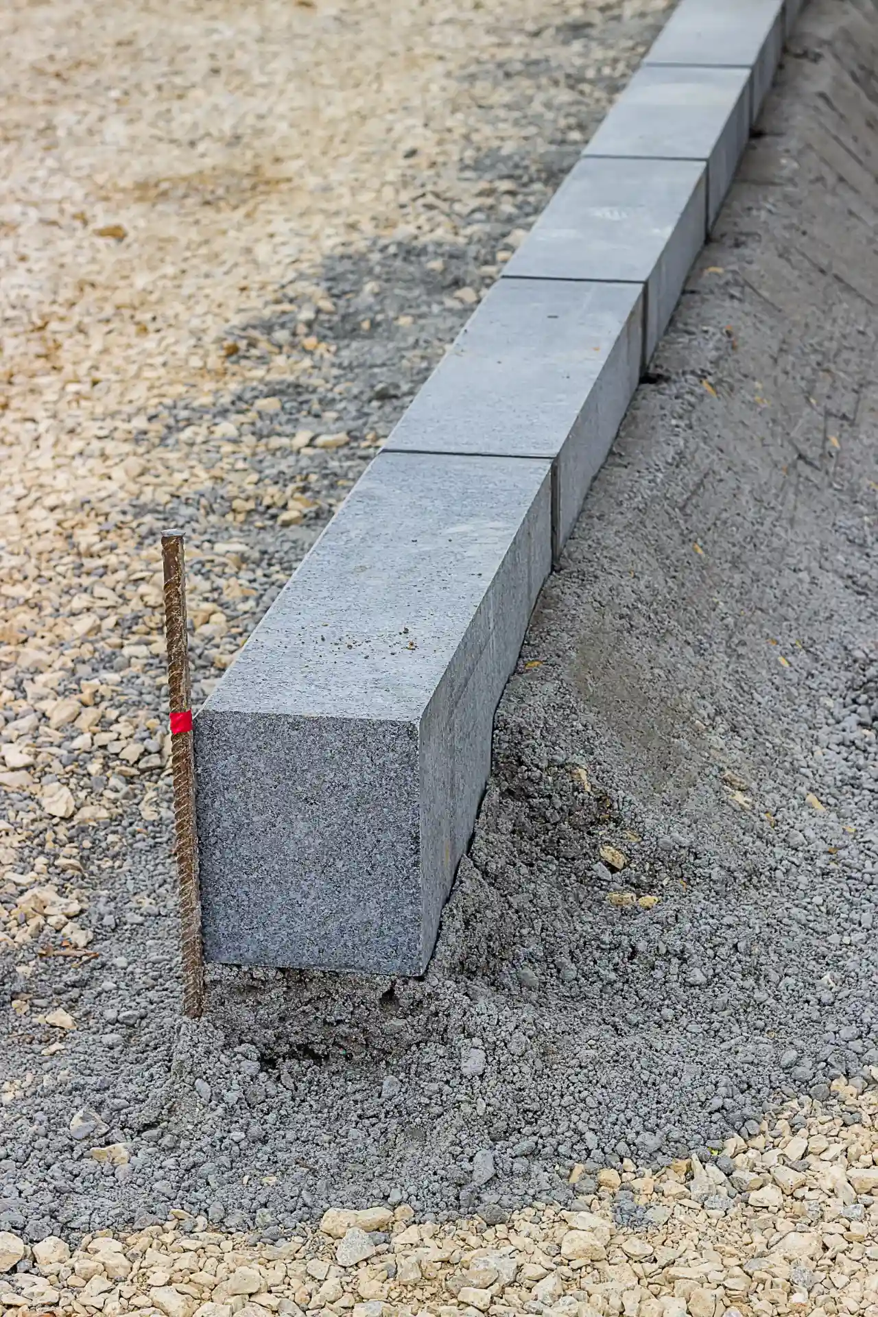 Granite stone and string line set for a New Jersey retaining wall