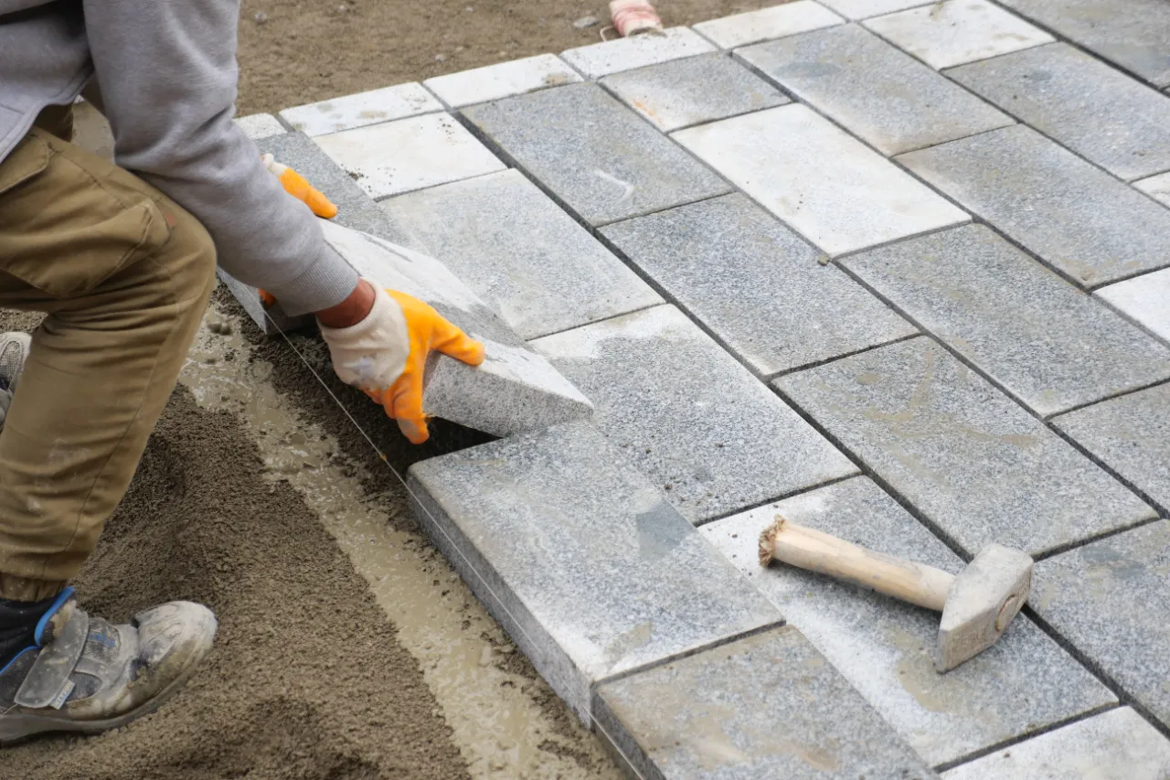Laying concrete bricks for a paver project in New Jersey