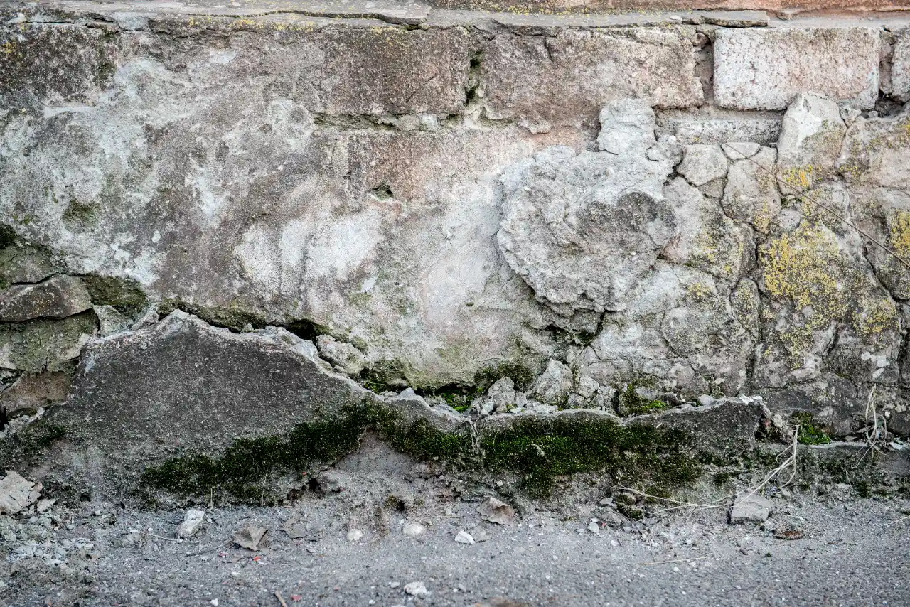 Weathered brick wall with moss and cracks in New Jersey