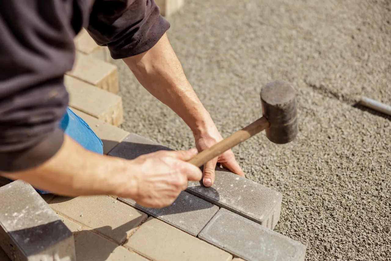 Laying grey concrete paving slabs in New Jersey